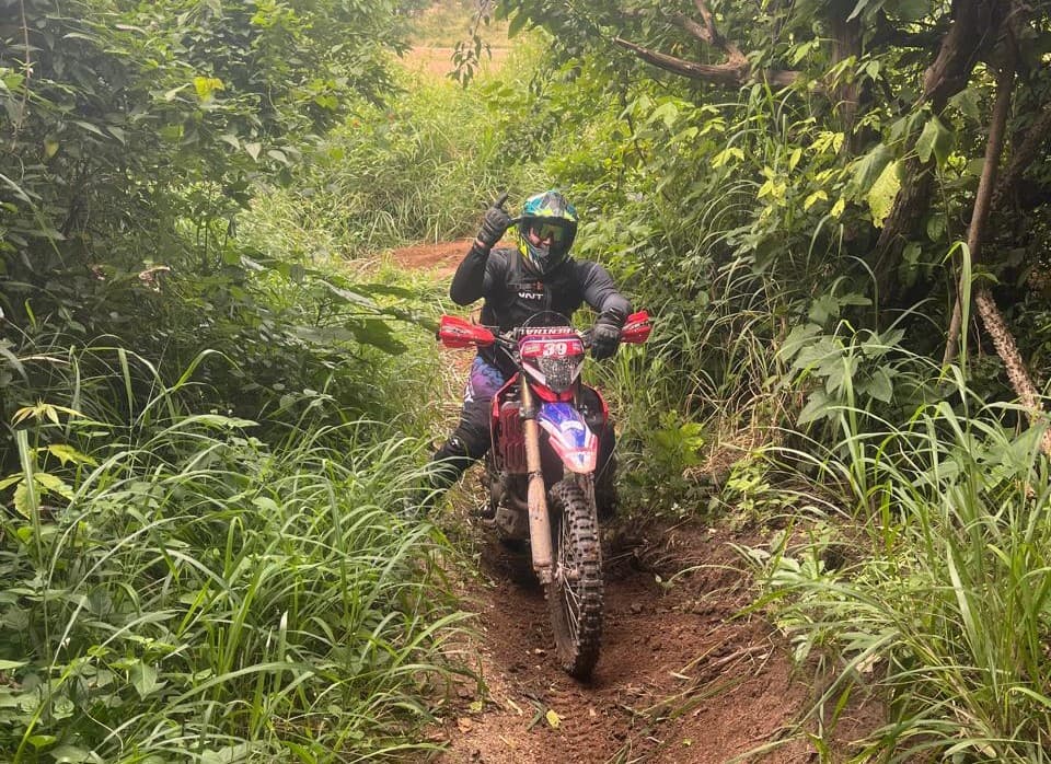 Rider on narrow jungle singletrack, Thailand enduro tour